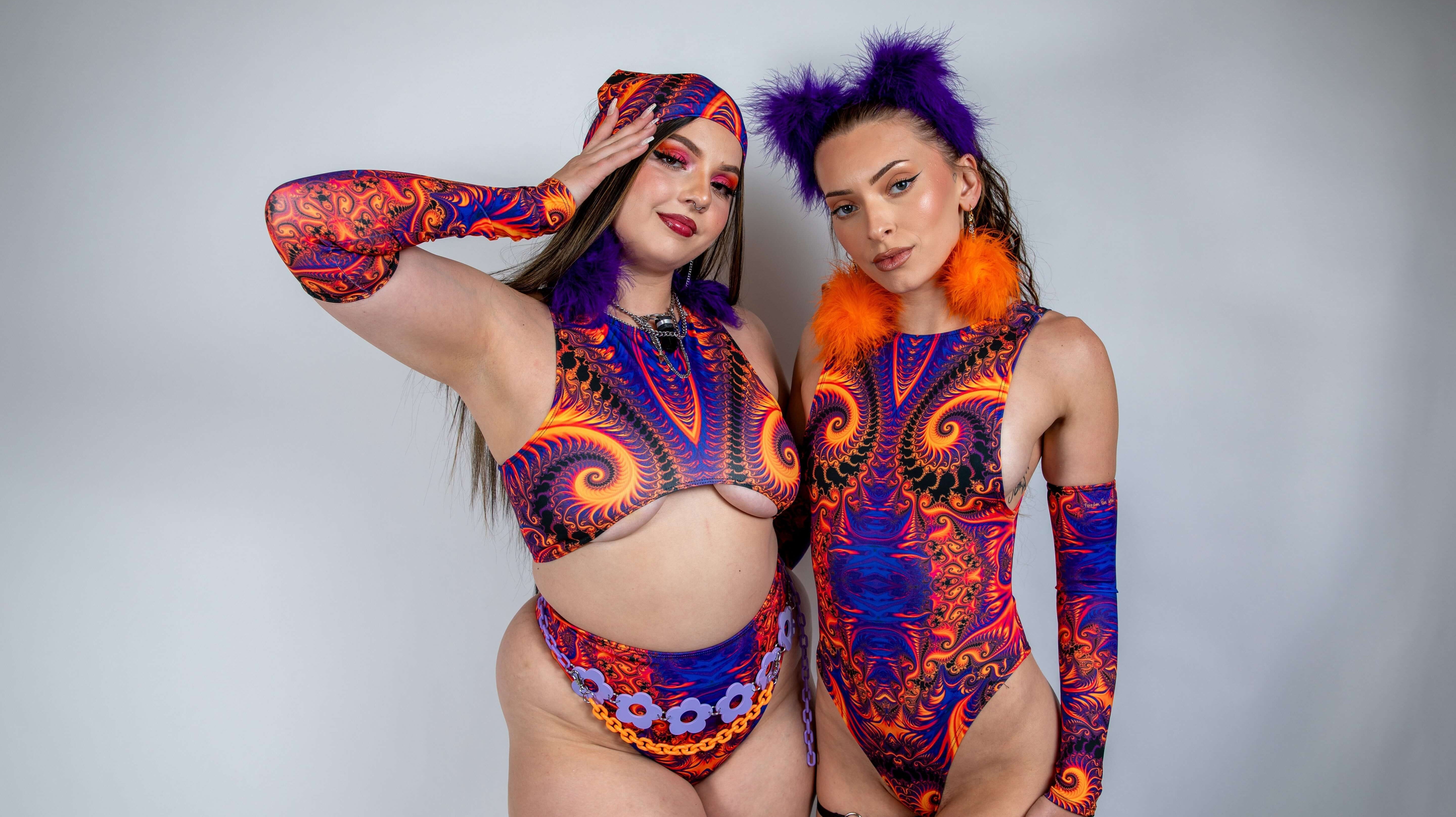 Two models showcasing vibrant rave outfits with intricate patterns in purple and orange colors.