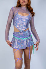 Stylish rave outfit featuring shimmering purple top and skirt with mesh and chain accents, perfect for EDC Las Vegas.