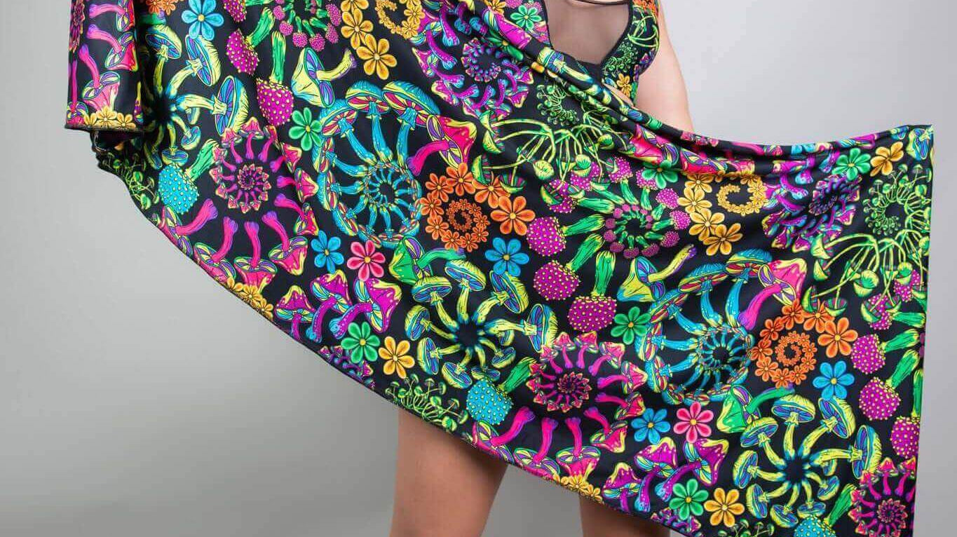 Woman showcasing a vibrant floral pashmina scarf, perfect for elevating rave outfits at festivals.