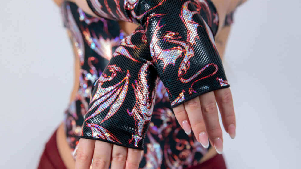 Woman modeling a stylish rave outfit with fingerless gloves, perfect for EDC 2025.