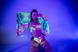 Model in vibrant neon rave outfit with colorful patterns, showcasing neon therapy benefits for mood and confidence.