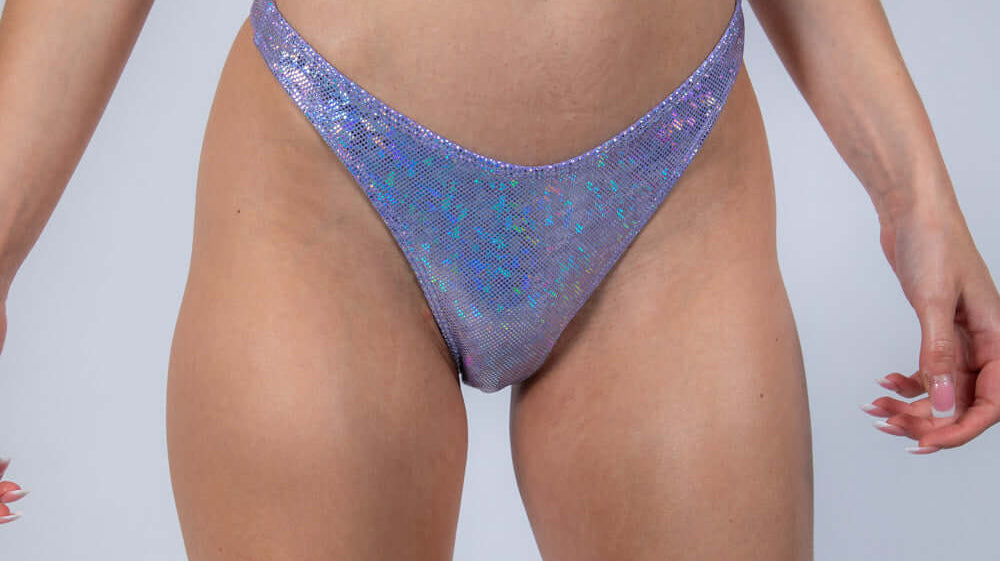 Shiny holographic rave outfit featuring a crop top and high-cut bottoms, perfect for cyberpunk dance floors.