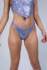 Shiny holographic rave outfit featuring a crop top and high-cut bottoms, perfect for cyberpunk dance floors.