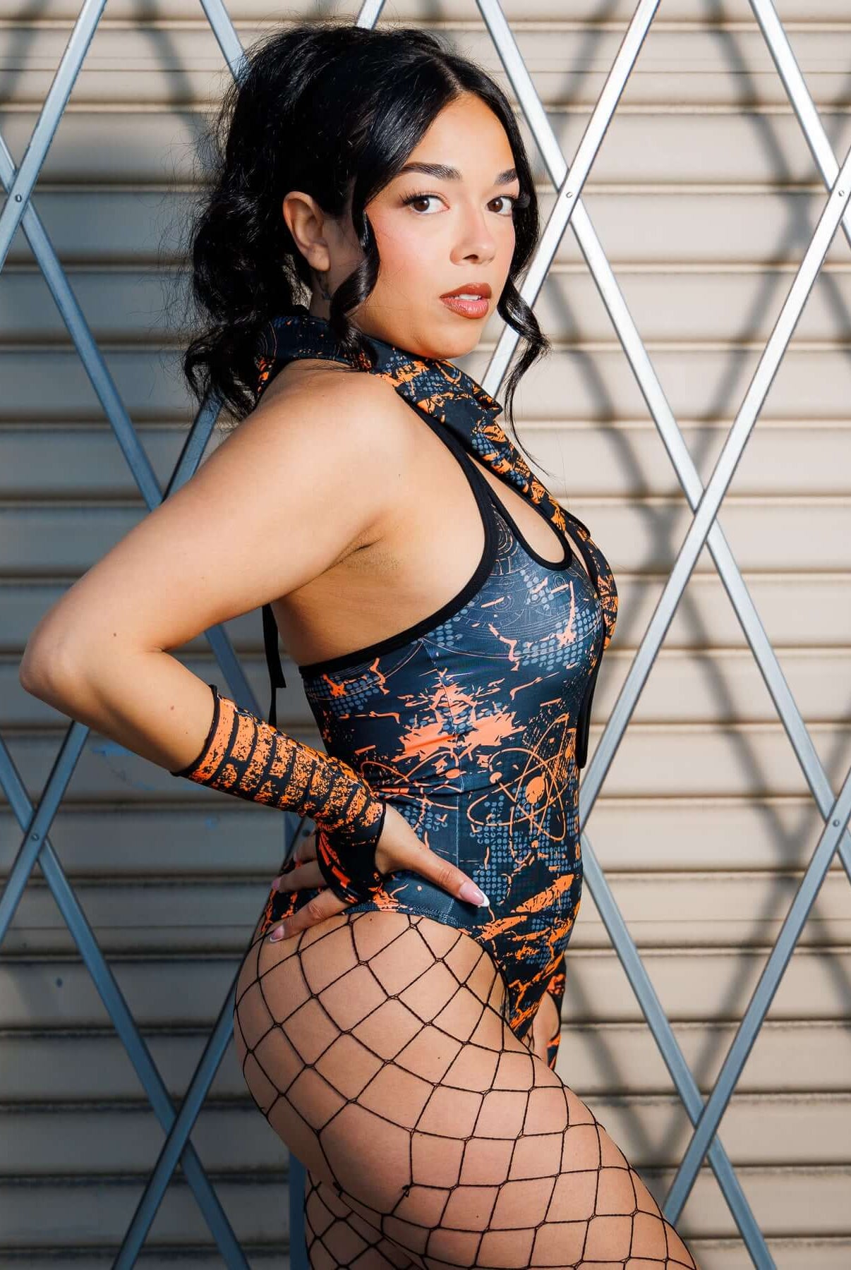 Model wearing Atomic Bandana in orange and black tones, styled as a headwrap with edgy post-apocalyptic flair, perfect for festivals.