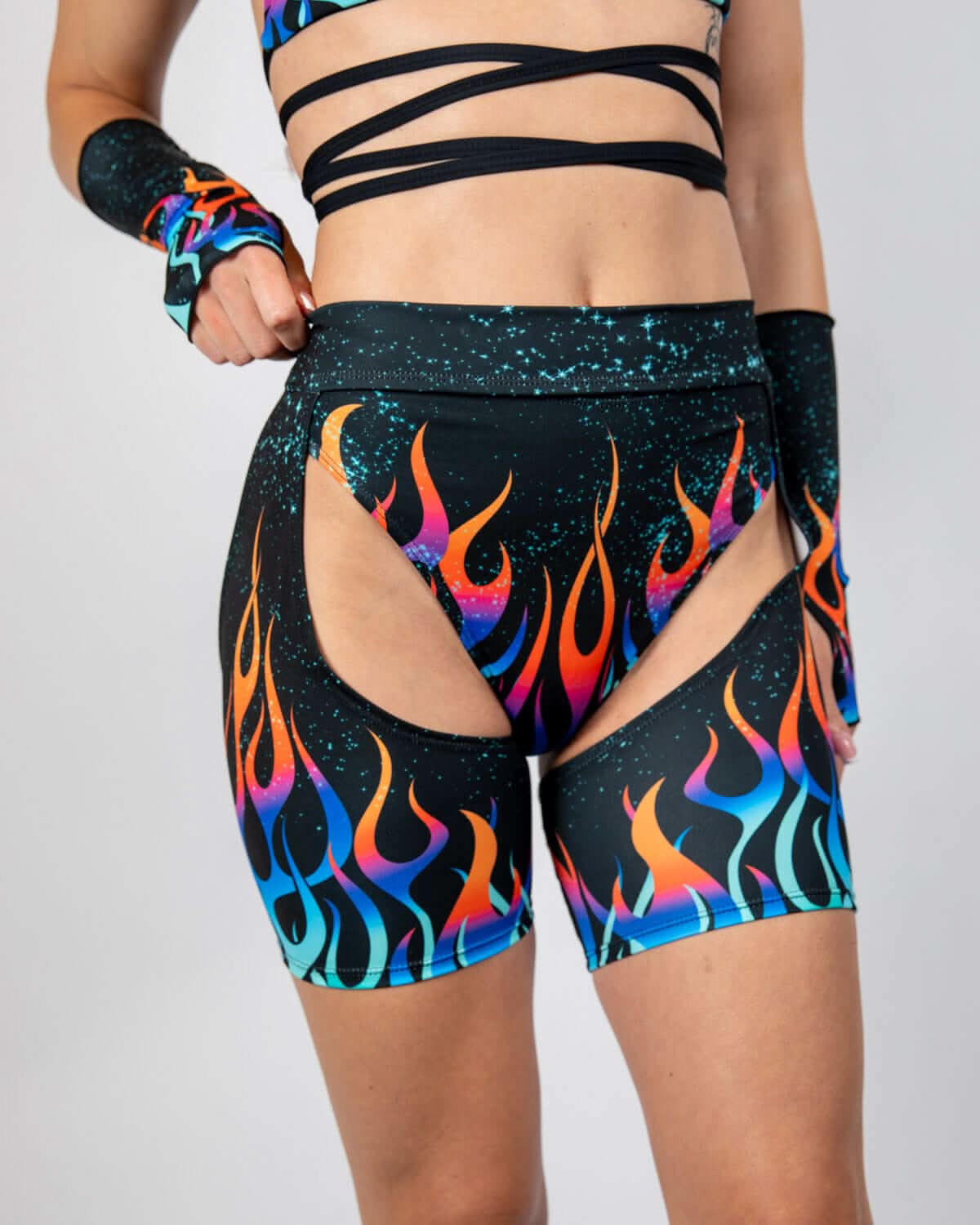 High-waisted Blaze Chaps with flame graphics, perfect for bold rave outfits and festival fashion.