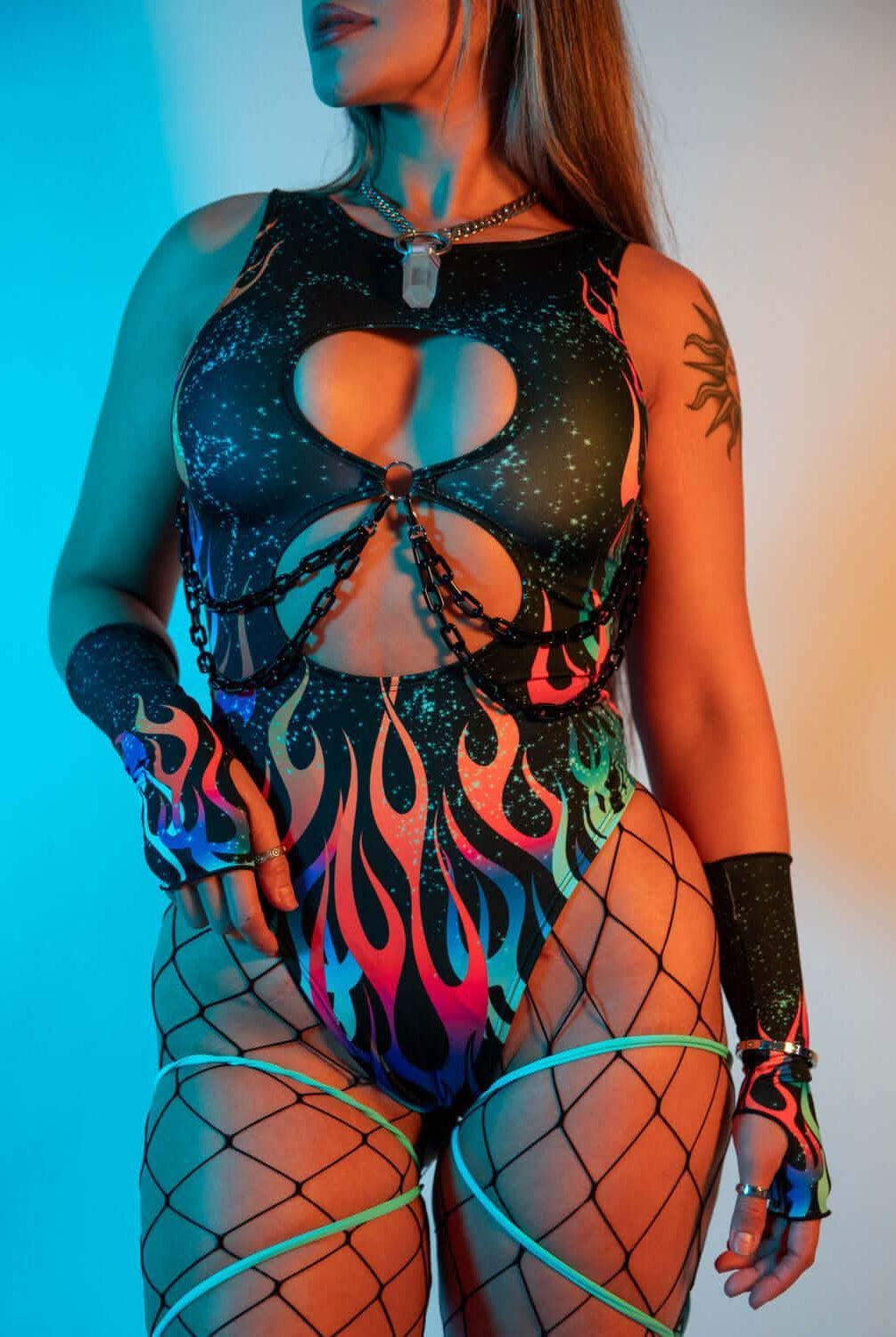 Model wearing the Blaze Keyhole Bodysuit featuring flame print and keyhole cutouts, perfect for rave outfits.