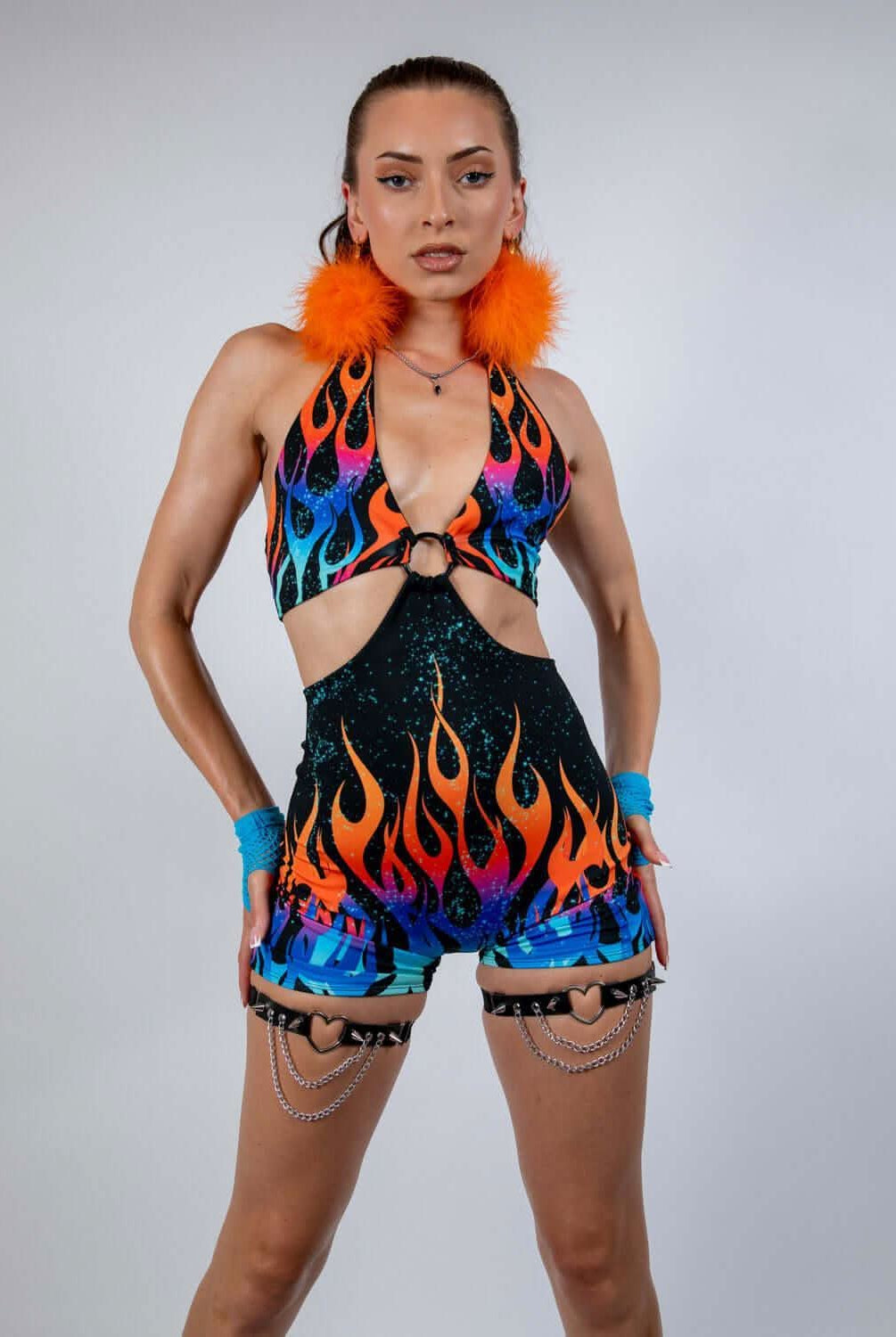 Model wearing the Blaze Romper, a vibrant halter neck outfit with flame print, perfect for rave outfits.