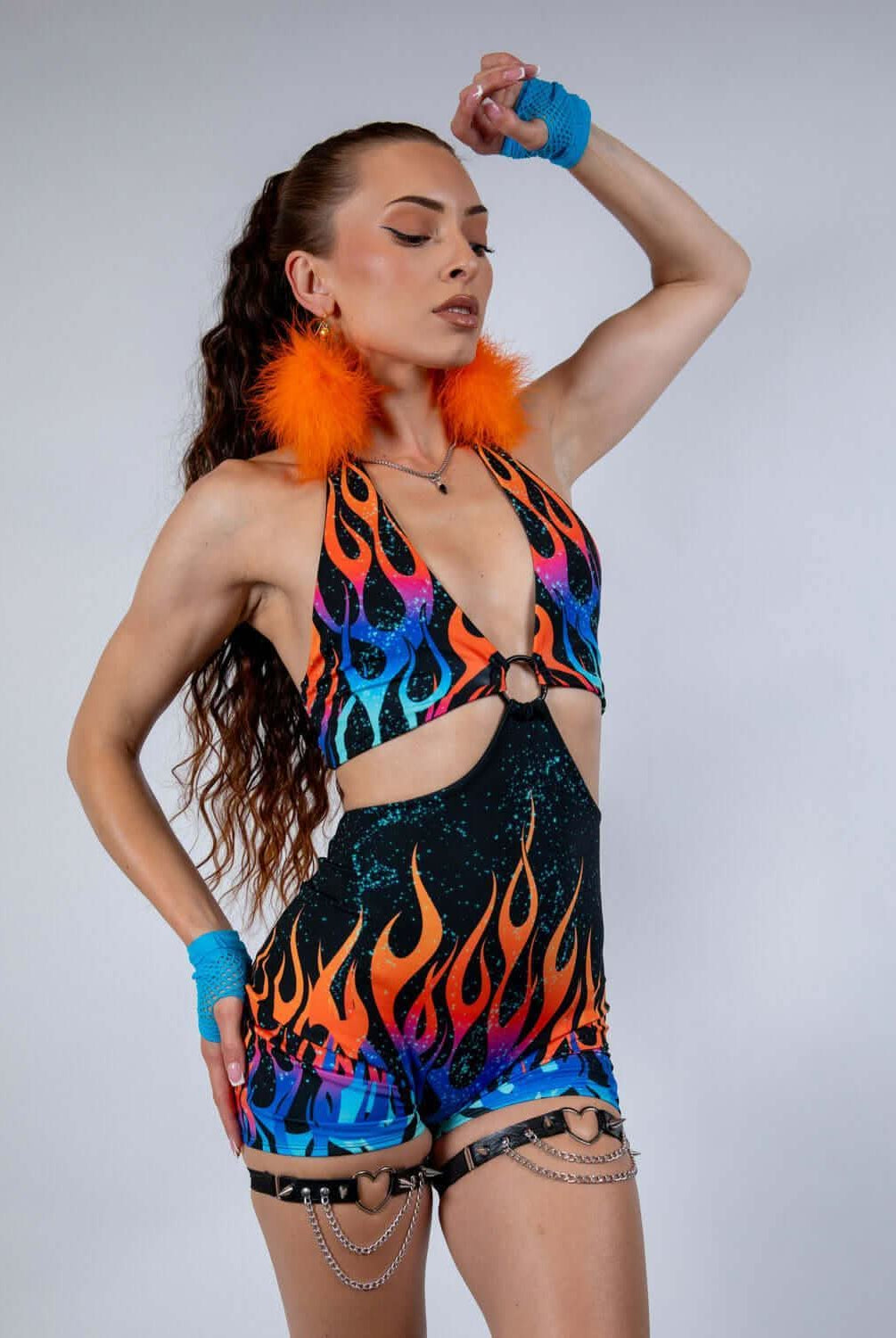 Woman in a fiery Blaze Romper featuring a plunging halter neckline and celestial flame print, ideal for rave outfits.