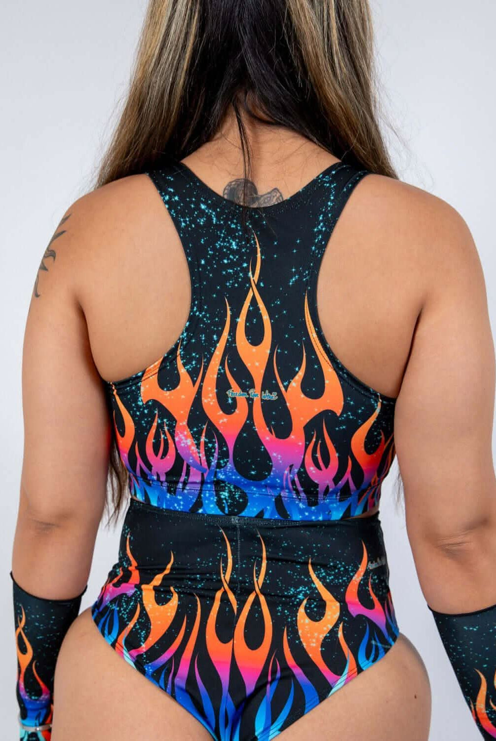 Back view of the Blaze V Free Top featuring a bold flame print and sheer mesh panels, perfect for rave outfits.