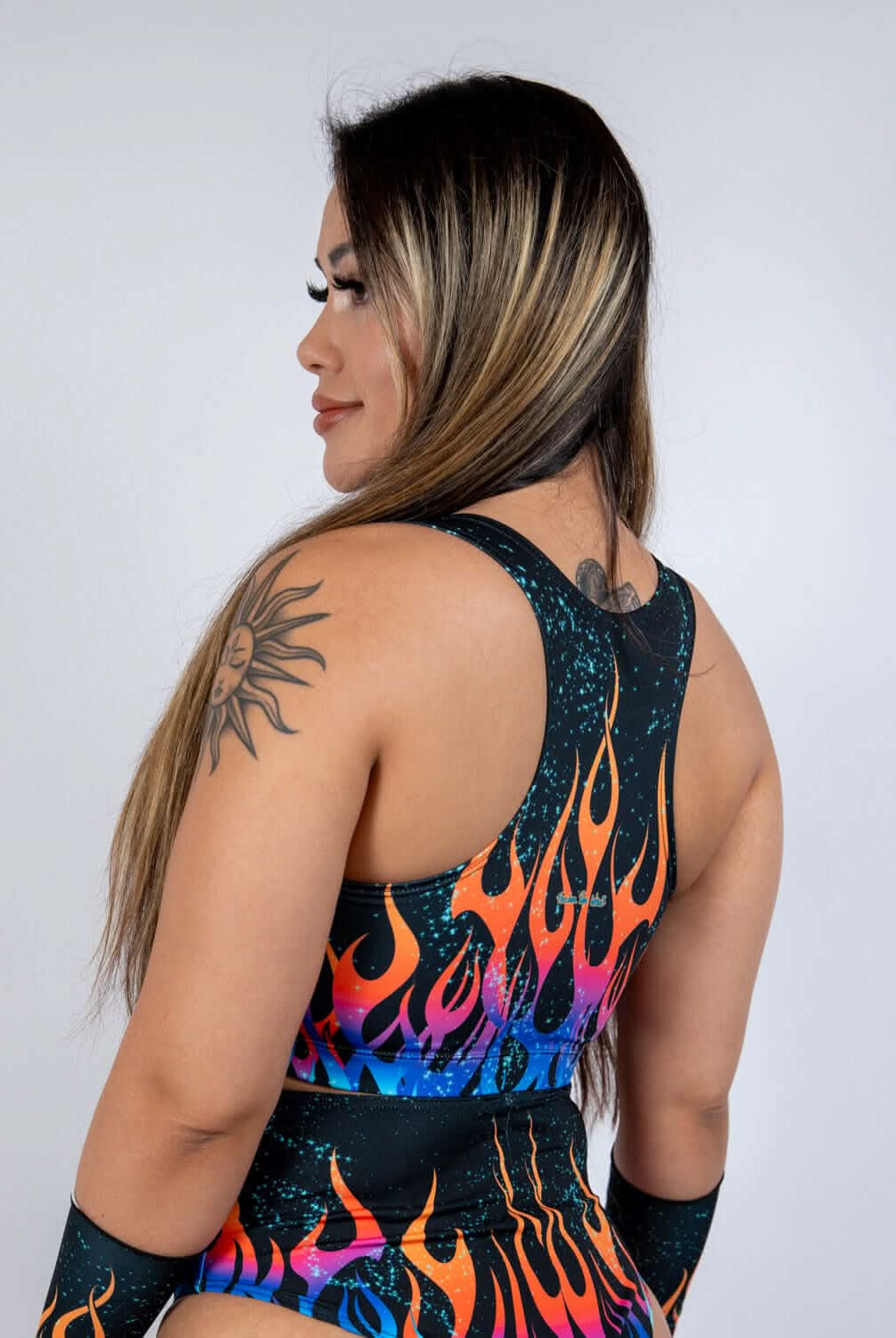 Side view of a model wearing the Blaze V Free Top, featuring a bold flame print and wide tank straps.