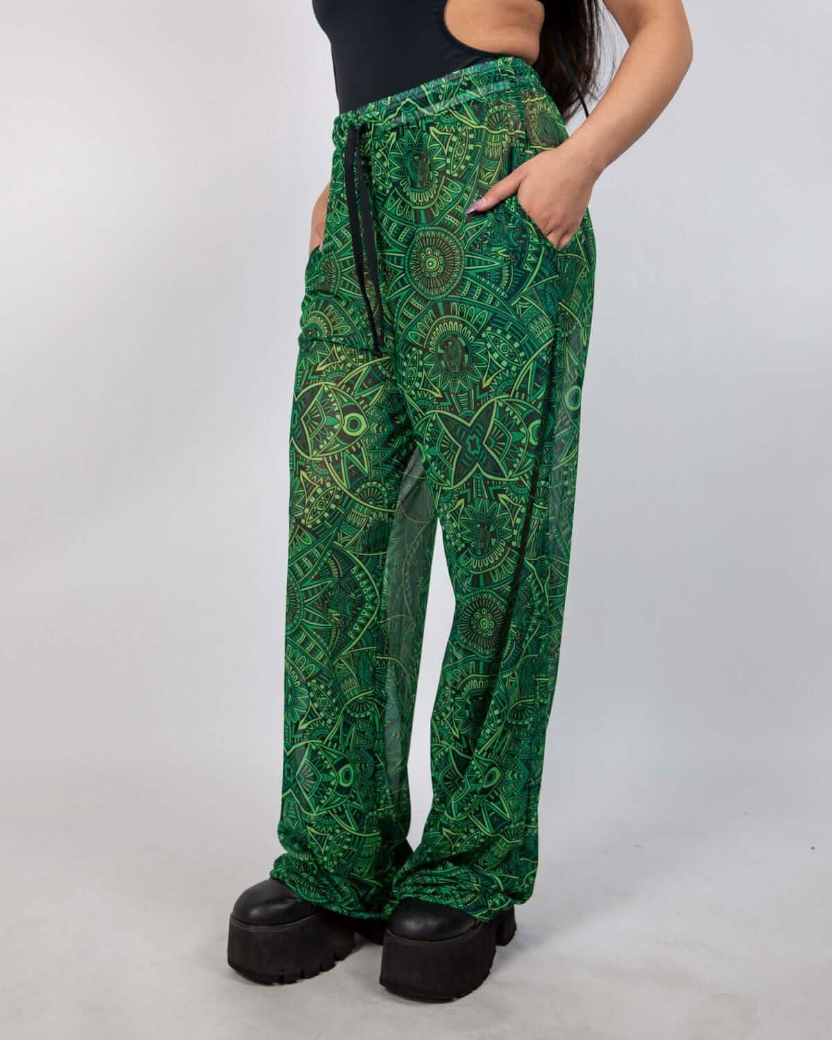 Dominion Mesh Lucy Pants featuring vibrant tribal print, pockets, and wide leg design perfect for rave bottoms.