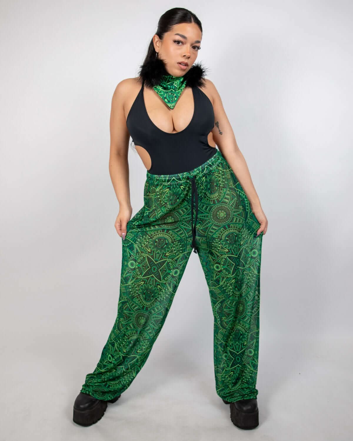 Model showcasing Dominion Mesh Lucy Pants with neon green tribal design, perfect rave bottoms for style and comfort.