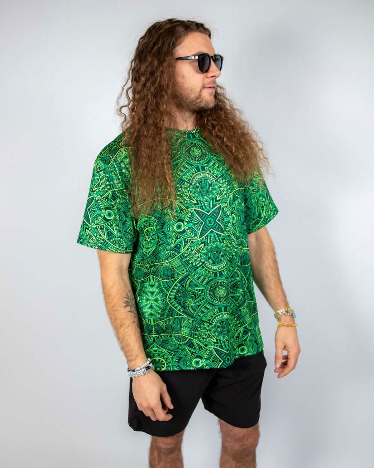 Dominion Oversized Softee rave t-shirt featuring bold green psychedelic pattern and relaxed fit style.