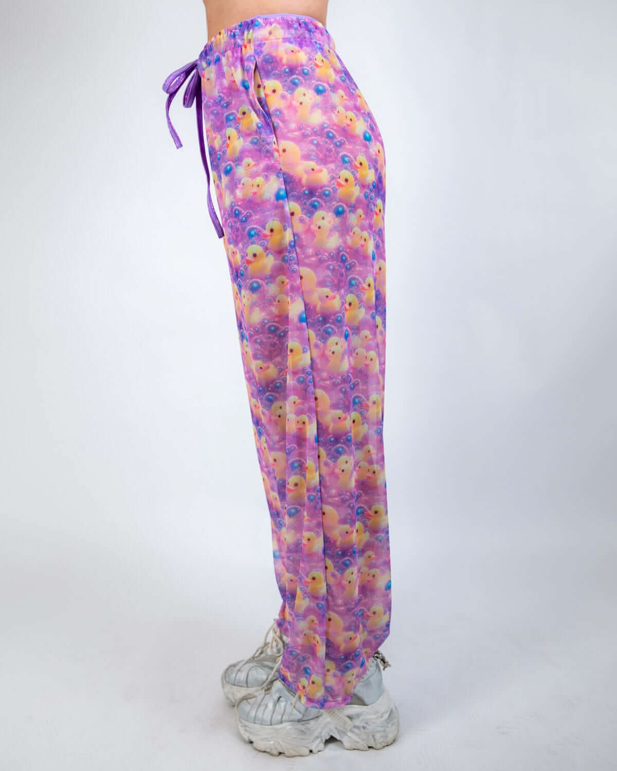 Side view of Duckies Mesh Lucy Pants in purple, yellow, and pink for rave outfits, featuring a wide leg and adjustable waistband.