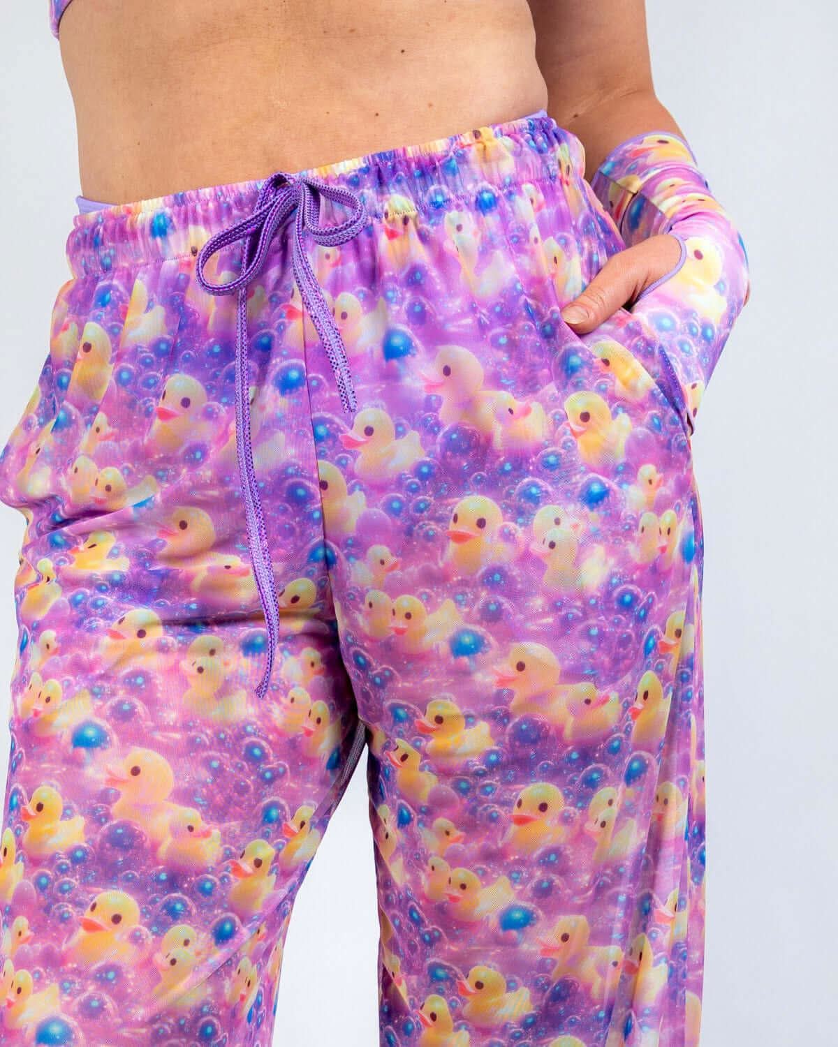 Duckies Mesh Lucy Pants in vibrant purple and pink color print with duck designs, perfect for rave outfits.