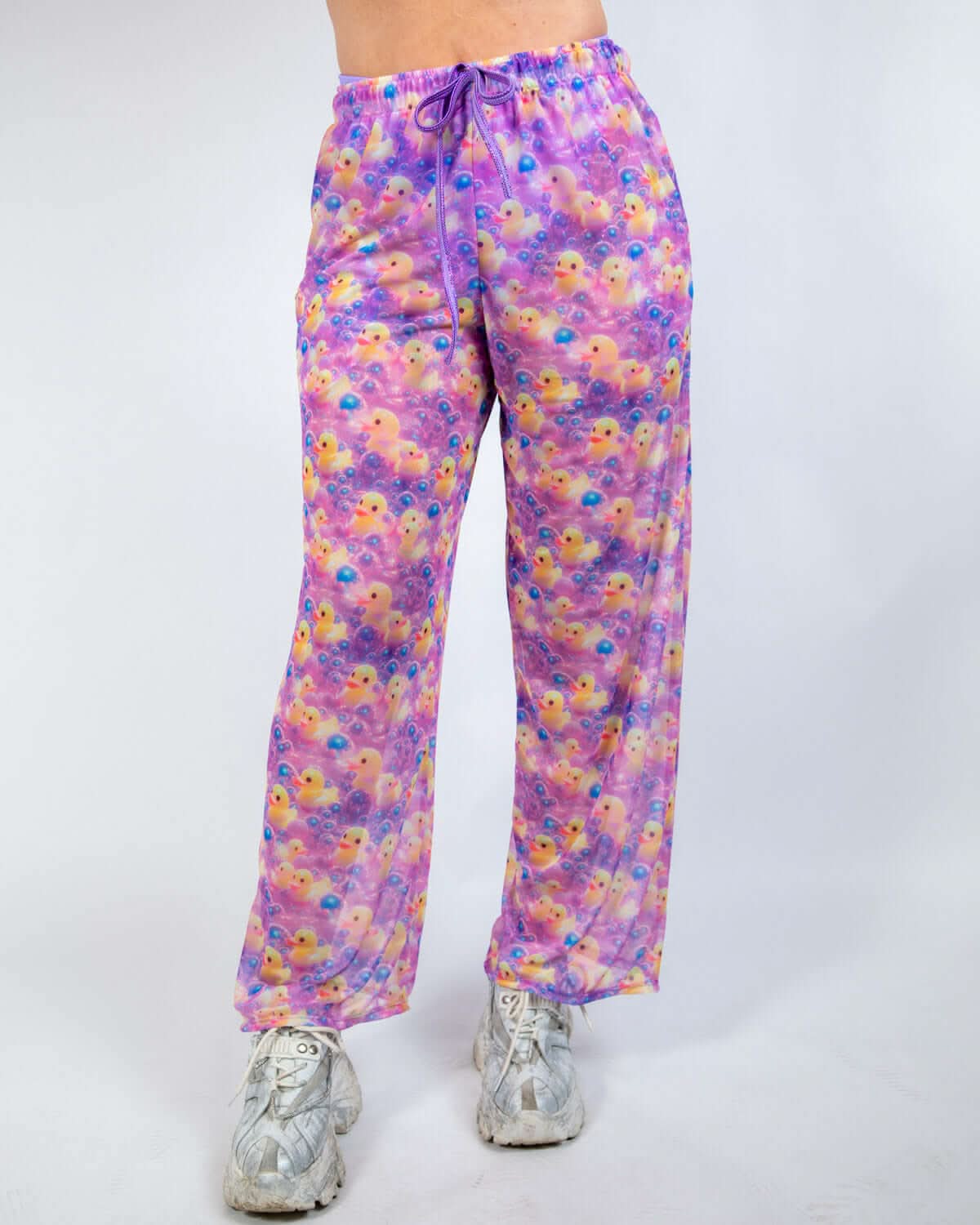 Duckies Mesh Lucy Pants in vibrant purple, yellow, and pink print, perfect for rave outfits with wide-leg silhouette.