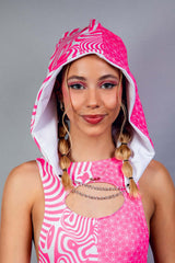 A woman with a soft smile wearing a pink and white bodysuit with a matching hood.