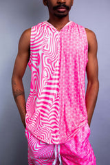 A man wearing a pink and white tank top with a hood and matching pants.