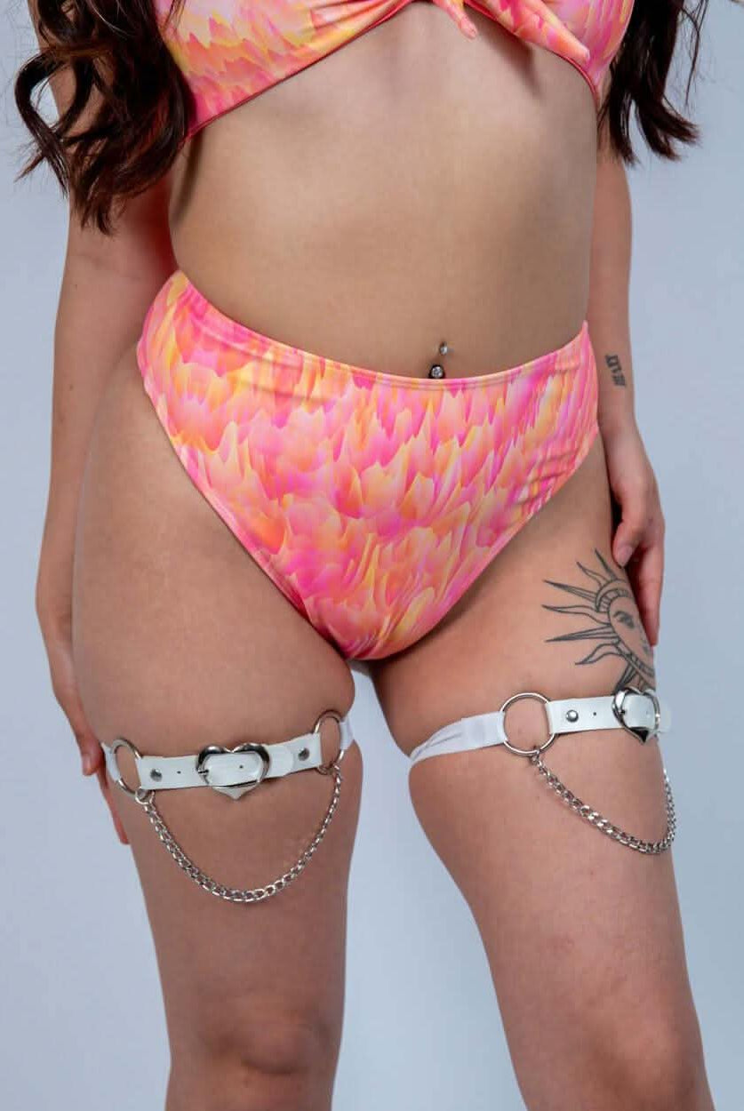 Model wearing a pink floral high waisted thong and harness, showcasing a confident rave outfit for summer.