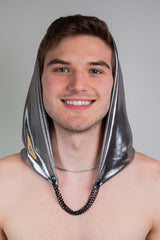 A photo of a man smiling at the camera wearing a silver hood.