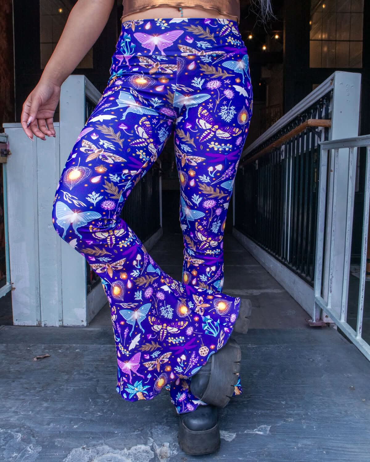 Lucent Bell Bottoms in vibrant print, perfect for rave outfits, showcasing glowing flora and dramatic flares.