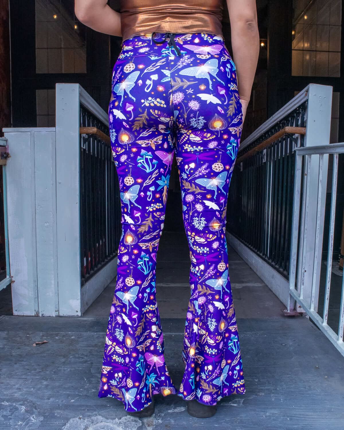 Lucent Bell Bottoms featuring a vibrant bioluminescent print, perfect for Rave Outfits and retro fashion.