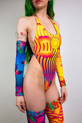Freedom Rave Wear's vibrant halter bodysuit with matching arm and leg sleeves, showcasing sun and wave patterns