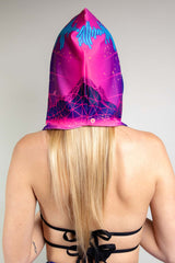 A woman facing away from the camera wearing a neon pink rave hood and a black tie bikini.