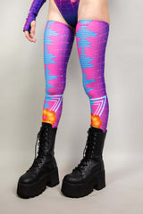 A woman's legs, dressed in leg sleeves with a neon synthwave design in blue and pink. The sleeves go up to her upper thigh.