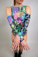 Model wears a Freedom Rave Wear neon psychedelic bodysuit featuring vibrant patterns on arm sleeves.