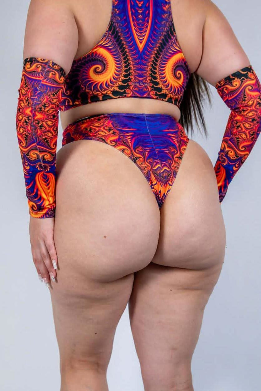 Woman modeling Radiance High Waisted Thong and colorful arm sleeves, perfect for rave outfits.