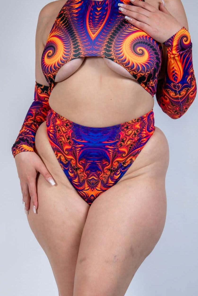 Model wearing a vibrant orange, violet, and pink high waisted thong with matching top, perfect for rave outfits.