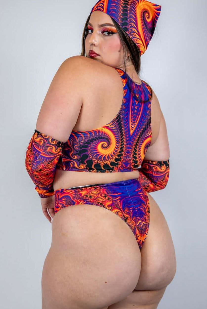 Model showcasing Radiance Teaser Top in vibrant swirl design, perfect for rave outfits and confident self-expression.