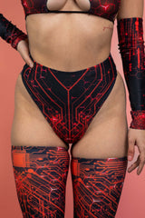 Close-up of the front of a woman in a black and red Freedom Rave Wear high-waisted bottom with intricate circuit design, paired with matching arm sleeves.