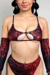 Close-up of a woman in a black and red Freedom Rave Wear bodysuit featuring a unique circuit pattern, styled with a central cut-out and matching arm sleeves