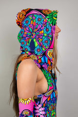A photo of the side of a girl's head wearing a rainbow stained glass printed hood and a matching bodysuit.