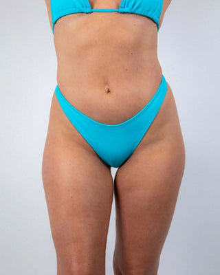 Siren Risk Bikini Bottoms in vibrant siren blue, high-cut silhouette for rave outfits and summer fun.