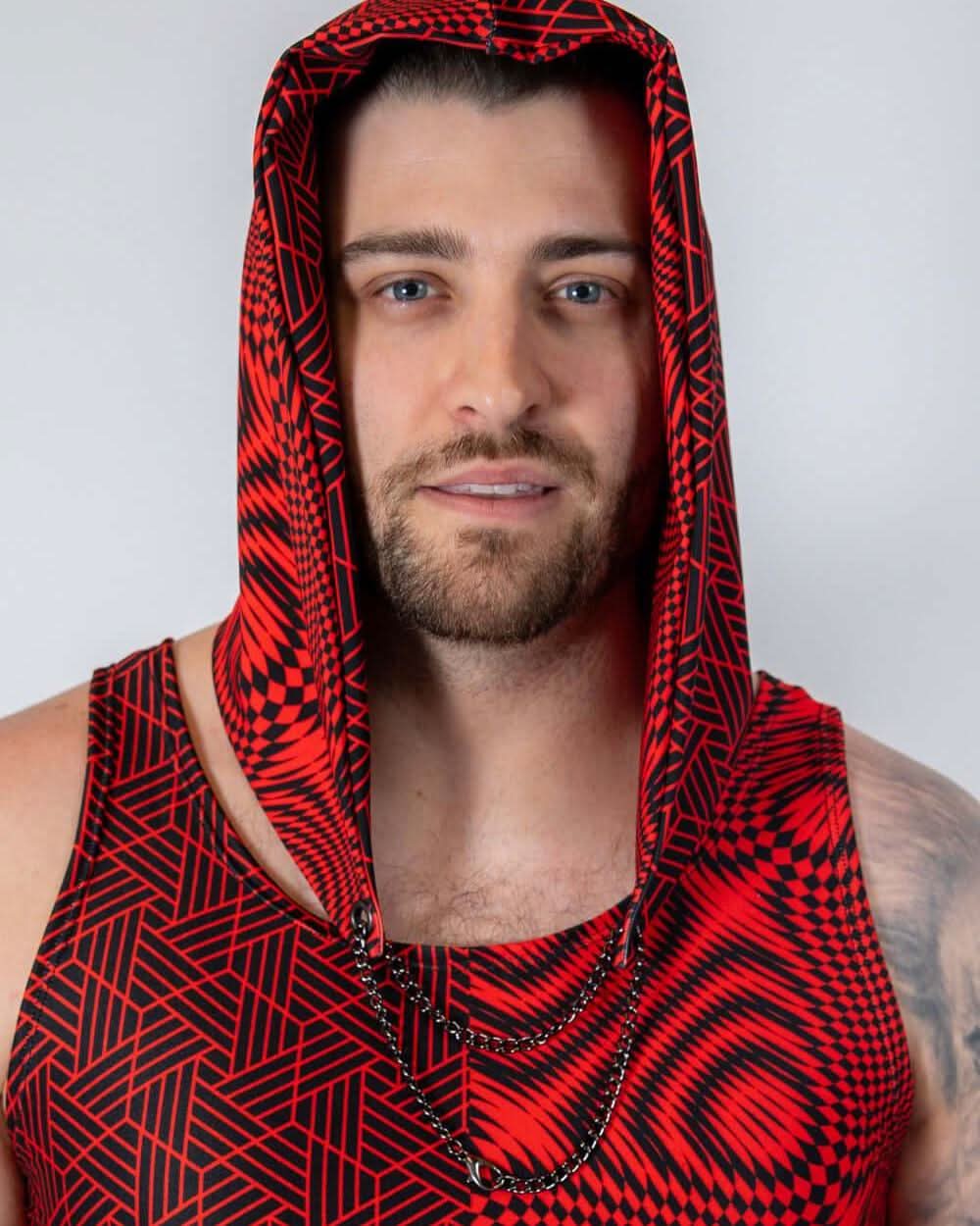 Man wearing Amplitude Assassin Hood in bold red and black geometric design, perfect for rave outfits.