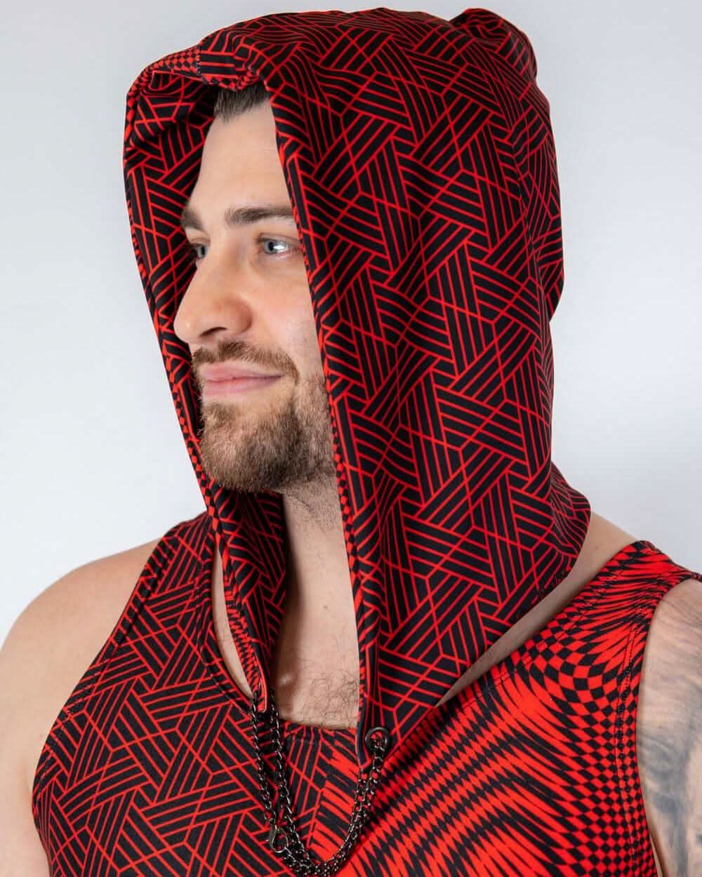 Man wearing the bold red and black Amplitude Assassin Hood, showcasing style and warmth for rave outfits.
