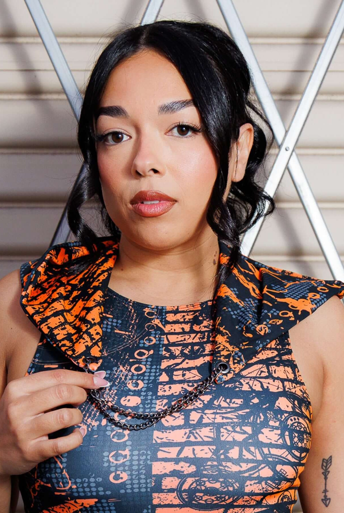 Woman wearing Atomic Assassin Hood in orange and black, featuring a dystopian design perfect for post-apocalyptic and rave themes.