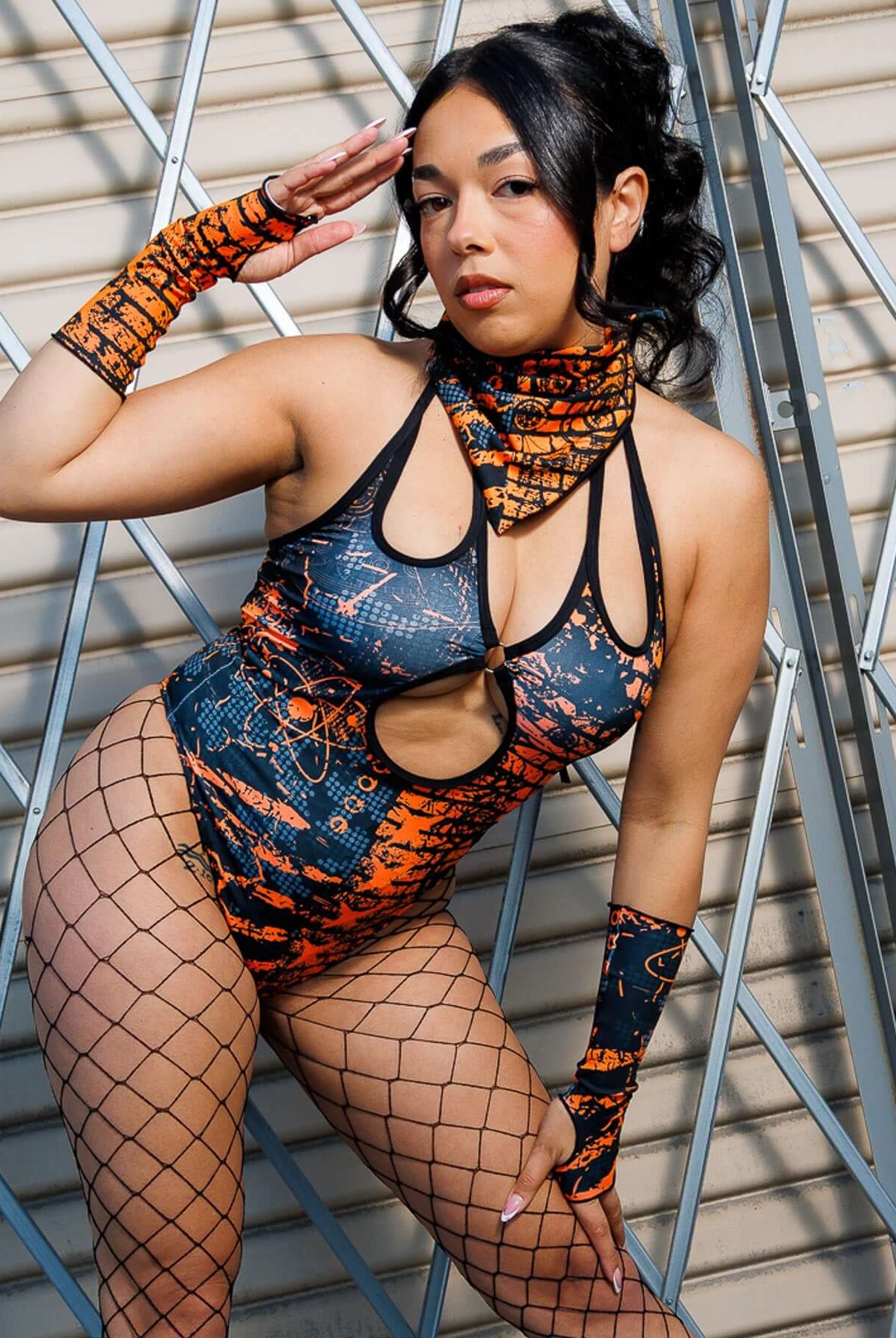 Model wearing Atomic Gloves with flame-meets-galaxy print, fingerless design. Perfect for rave energy and style.