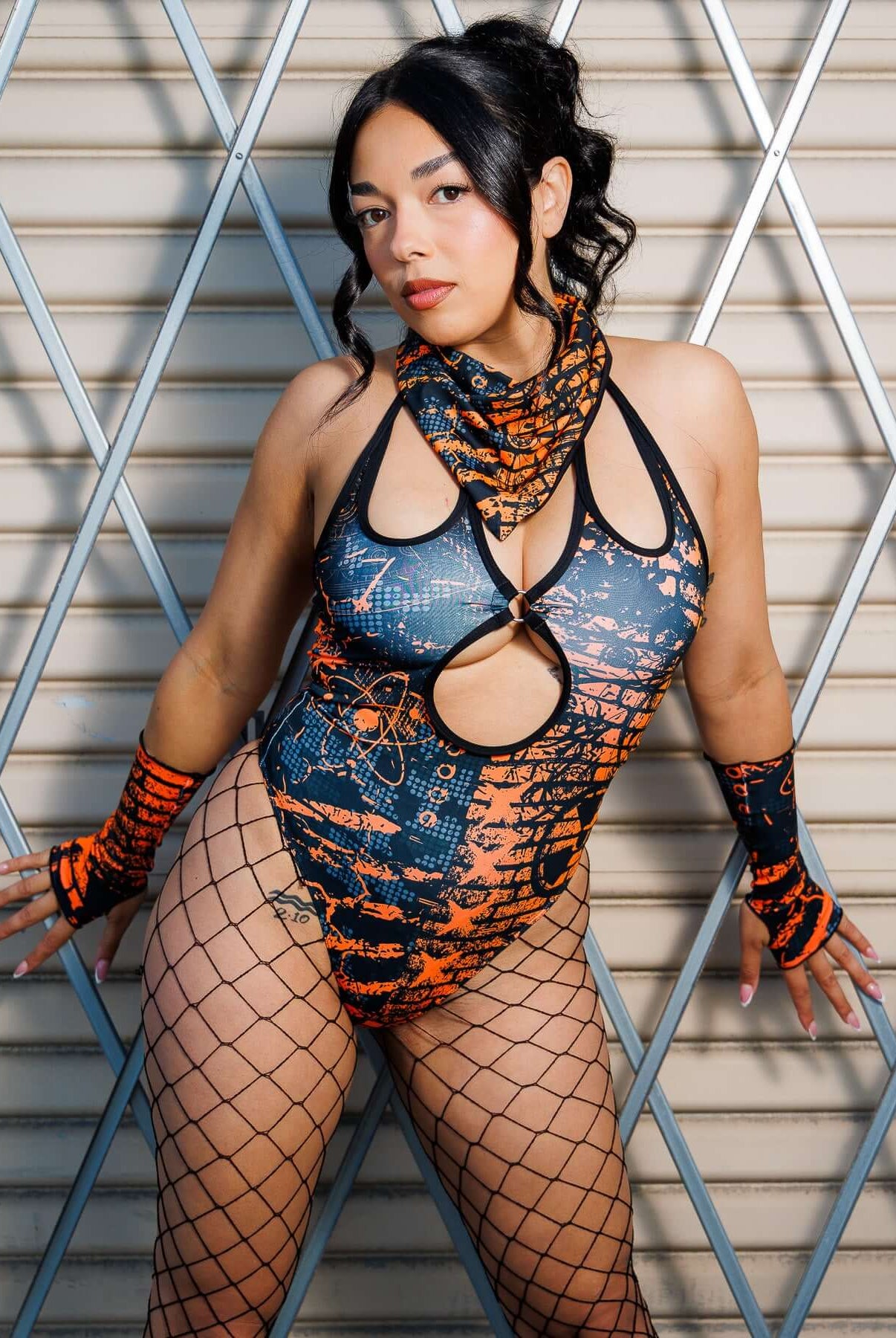 Model wearing Atomic Gloves with flame-meets-galaxy print, stylish rave accessory in orange and blue, showcasing attitude and comfort.