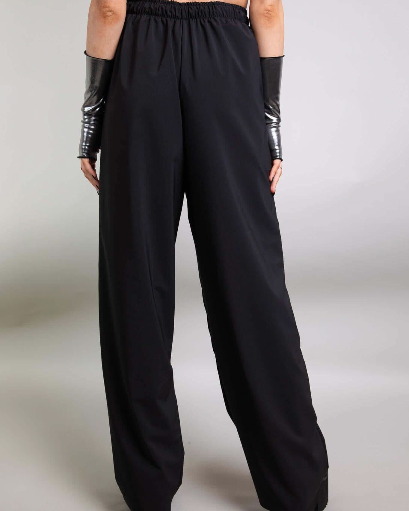 Back view of Basic Black Lucy Pants featuring wide legs and an elastic waistband, perfect for rave outfits.