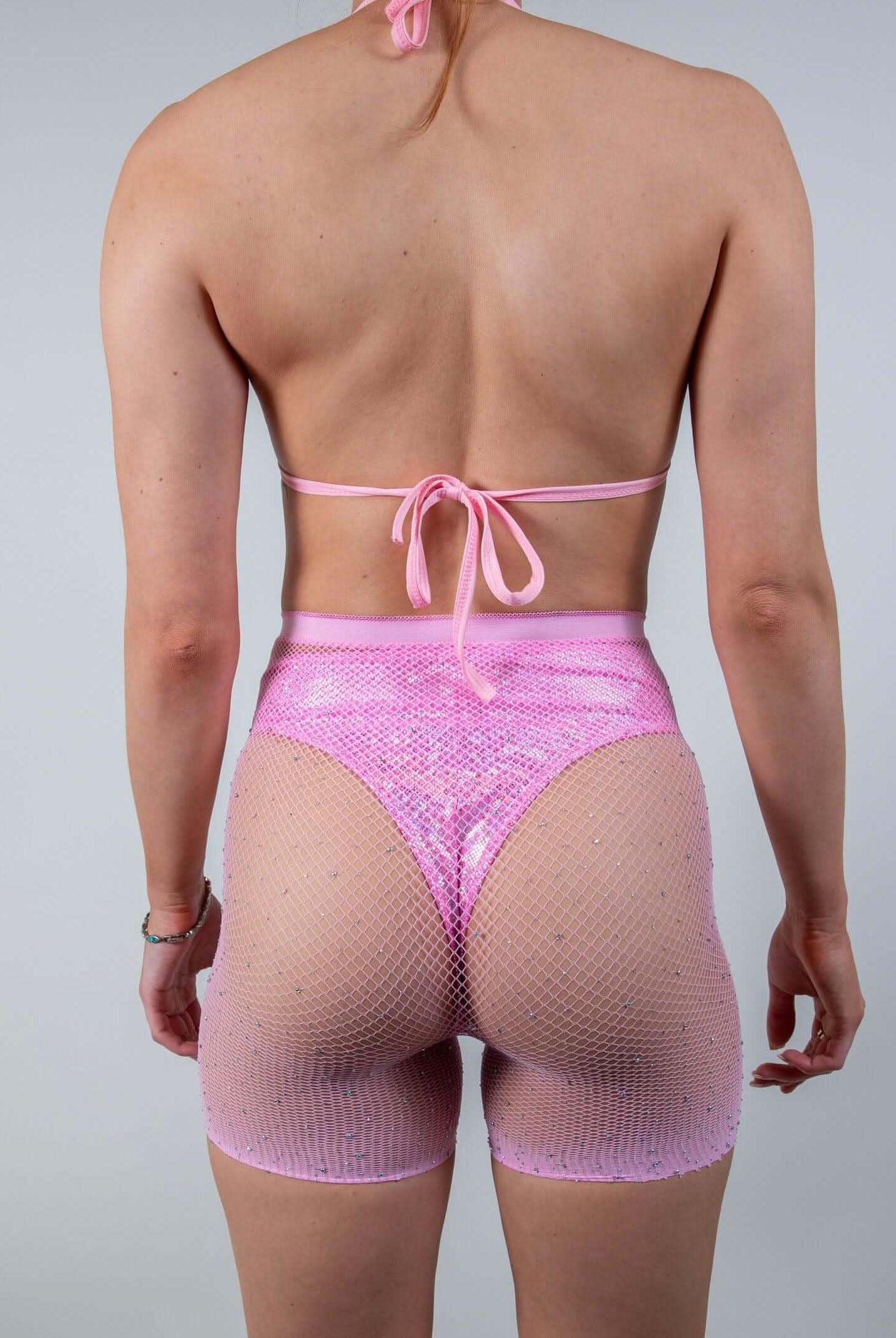 Back view of the Bikini Babe Rhinestone 2 Piece Fishnet Set in pink, highlighting the flattering fit and shimmering design.