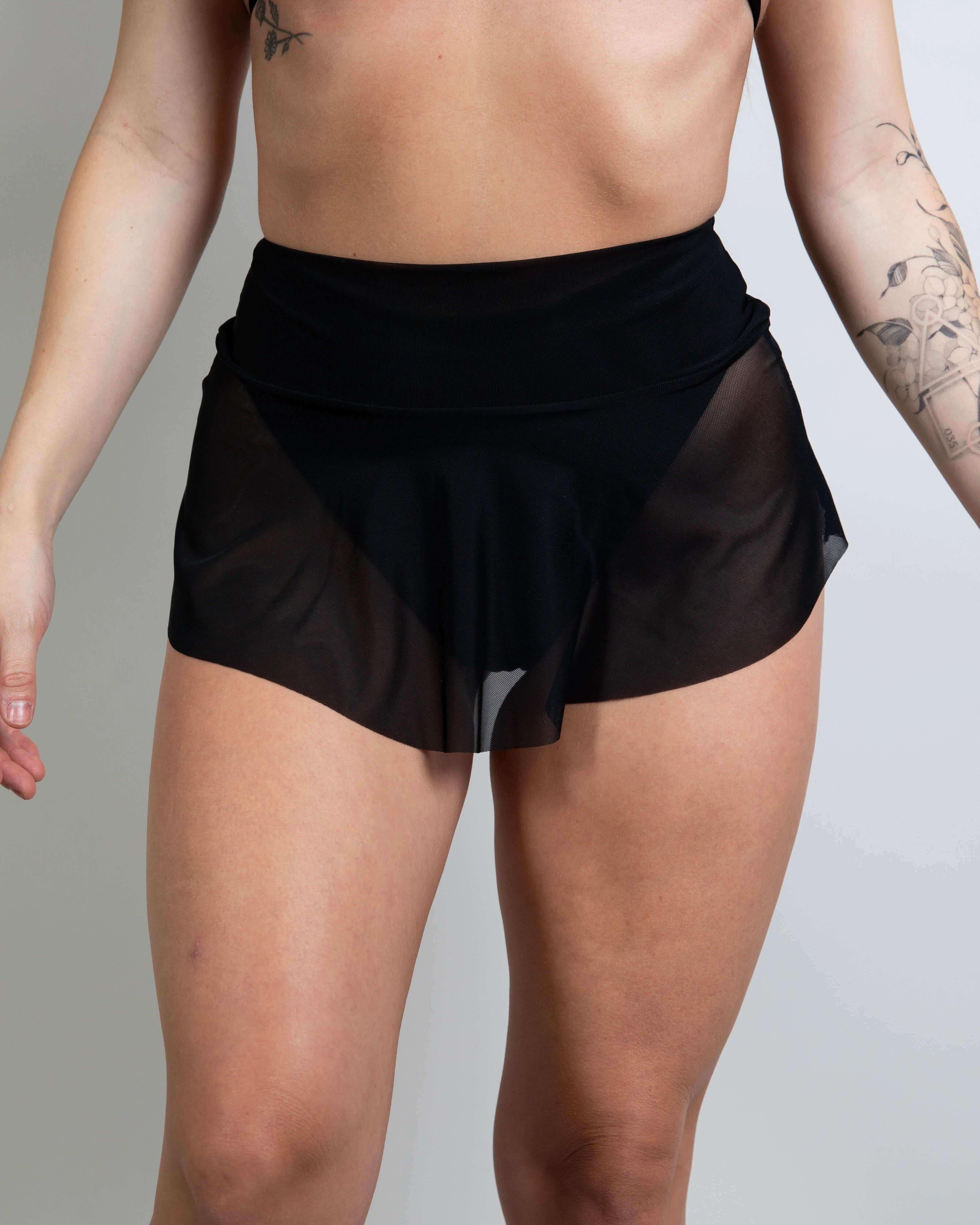 Black mesh micro skater skirt showcasing playful design, ideal for rave outfits and dancing at events.