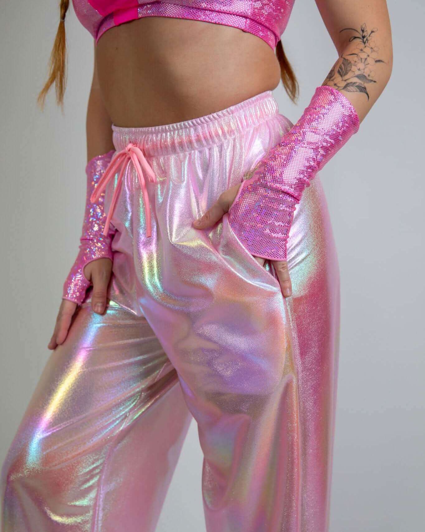 Model showcasing iridescent pink Bubble Gum Lucy Pants, perfect for rave outfits and stylish comfort.