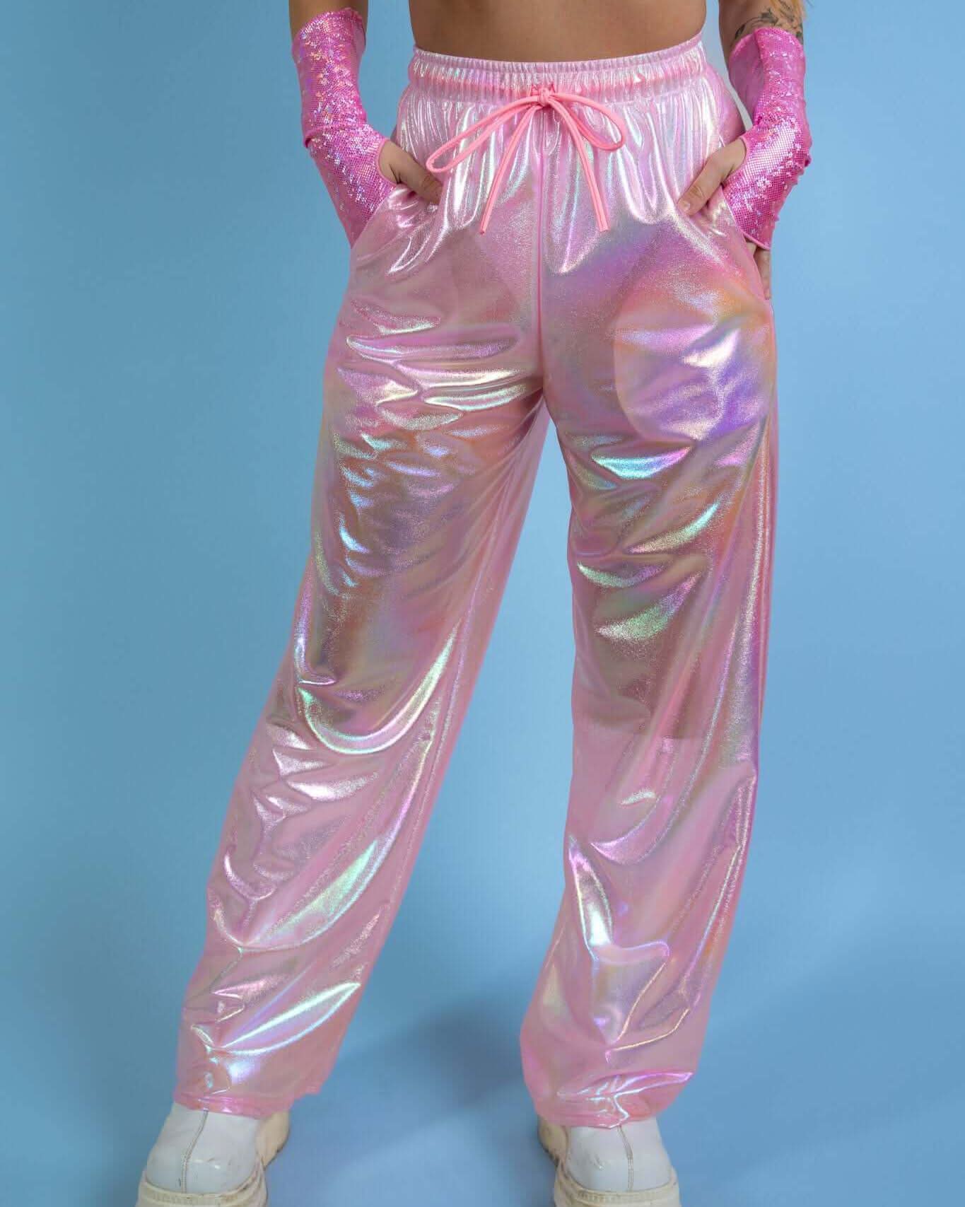 Iridescent pink Bubble Gum Lucy Pants, perfect for rave outfits, featuring convenient pockets and loose, wide-leg style.