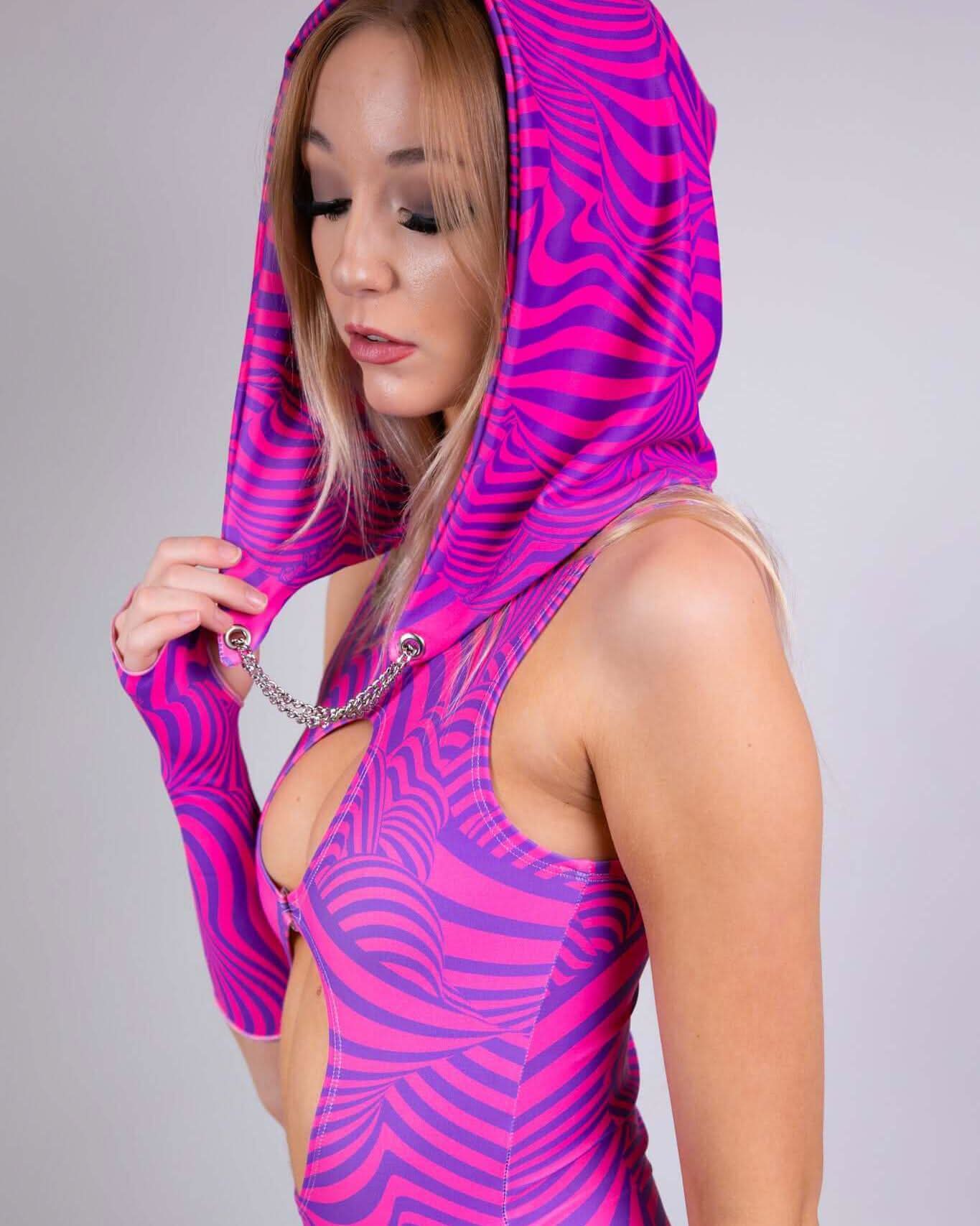 Model wearing a pink striped Cheshire Assassin Hood, showcasing its unique design and festival-ready style for rave outfits.