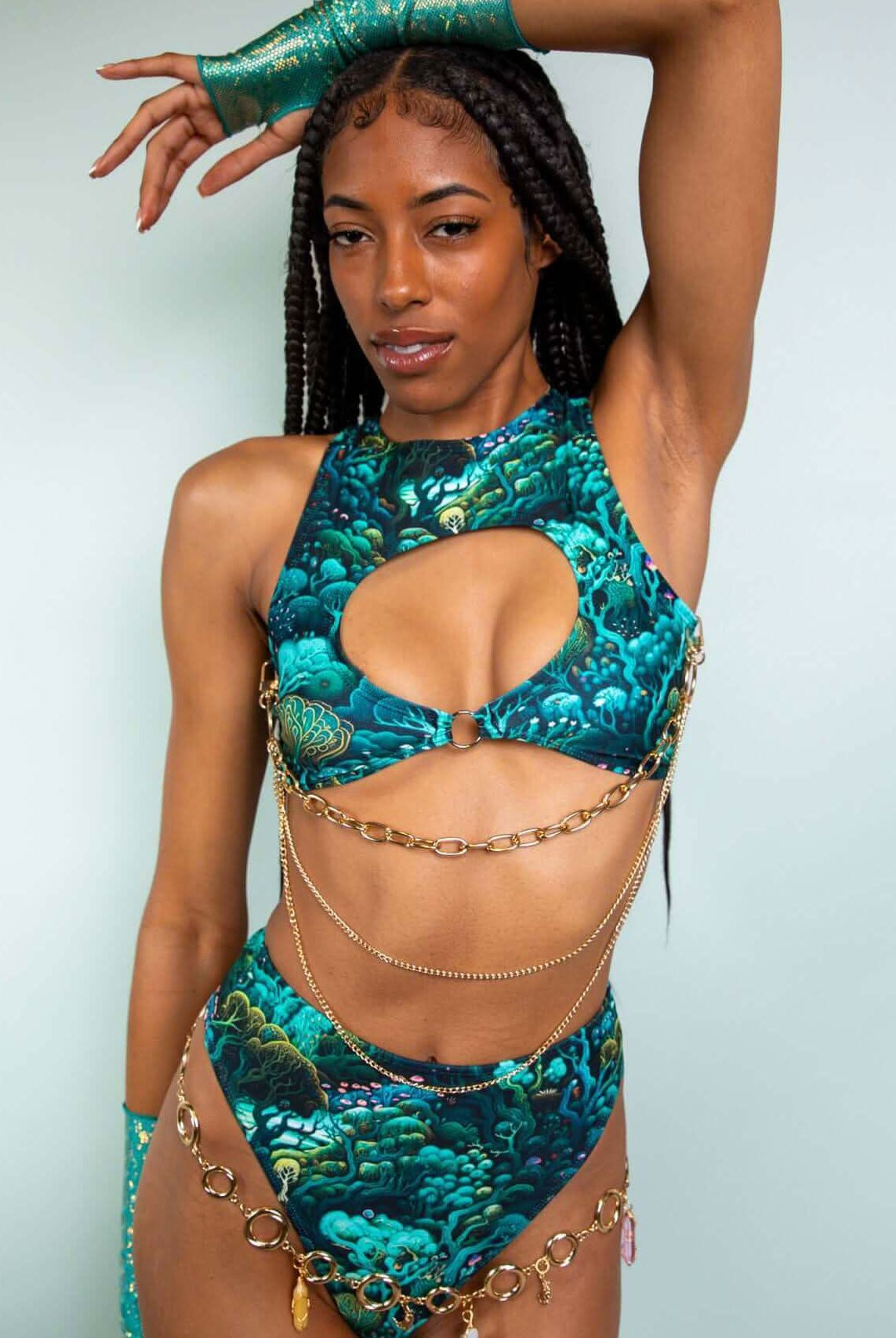 Model wearing Faewood Keyhole Top with keyhole cutout and chain details, showcasing a vibrant forest-inspired design.