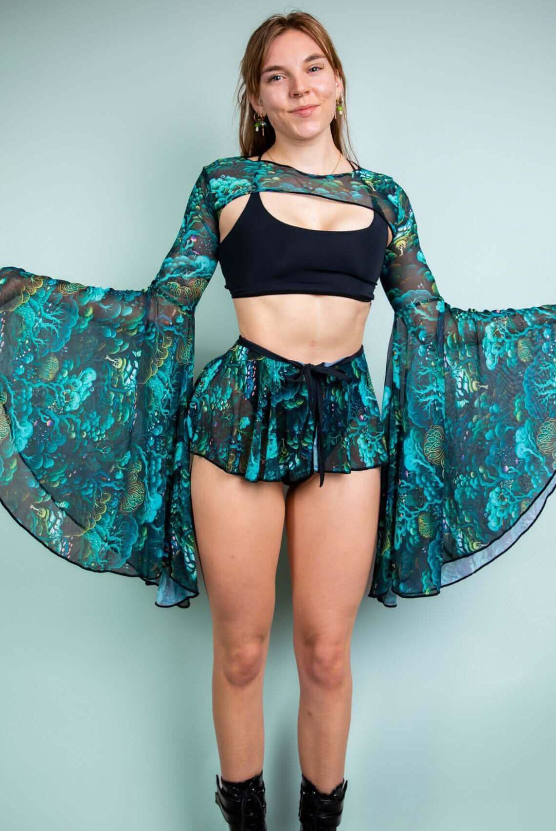 Model showcasing Faewood Mesh Bell Sleeves paired with a black top and matching shorts, perfect for vibrant rave outfits.